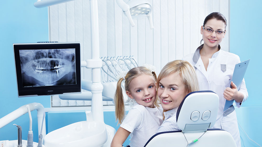 Happy family enjoying time together on a beach -CDCP dentist Toronto offers care covered by the Canadian Dental Care Plan for seniors, adults, and kids